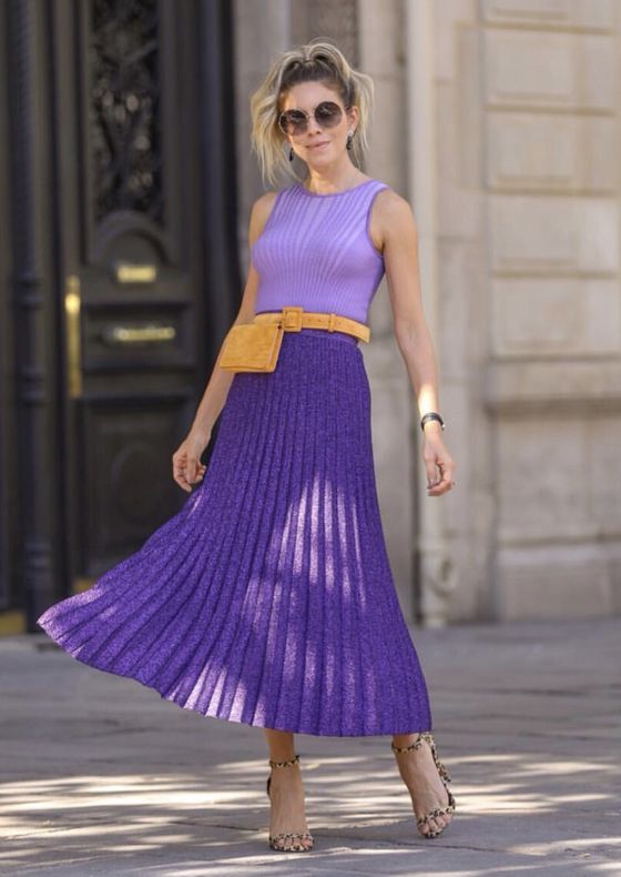 a lovely look with a light Very Peri sleeveless top, a Very Peri pleated midi skirt, leopard print shoes, a mustard belt and a waist bag