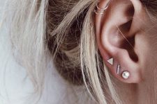 18 ultra-modern ear styling with a triple lobe piercing with chic gold studs and a double helix piercing done with hoops