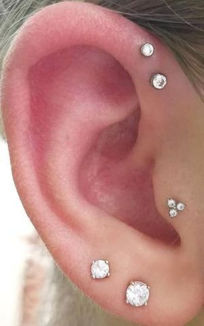 elegant ear styling with a double lobe, forward helix and tragus piercing all done with cool matching studs