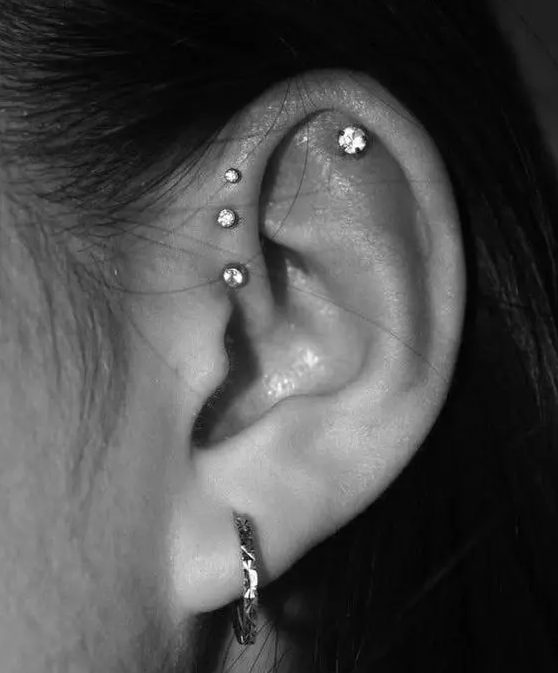 stylish stacked piercings - stacked foward helix ones plus an upper helix one and a lobe piercing are lovely