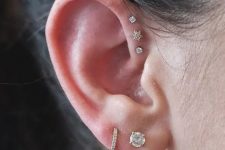 22 two lobe piercings paired with three forward helix ones, with pretty matching studs and hoops for a bold modern look