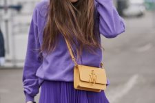 24 a bold monochromatic look with a Very Peri sweatshirt, a matching pleated skirt, a tan bag for spring