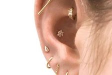 26 a modern look with a stacked lobe, a flat, a rook and a conch piercing, all done with beautiful studs and hoops