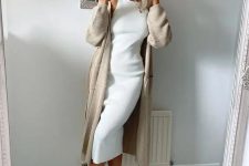 26 a white sleeveless midi dress, a tan long cardigan, white trainers for an airy and pretty spring look