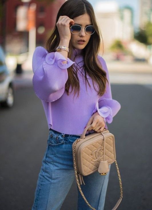 a chic and girlish look with a Very Peri top with ruffle sleeves, blue jeans, a tan box bag for every day