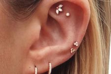 28 a double lobe, double helix and double flat piercing done with beautiful gold hoops, studs of various shapes for a wow look