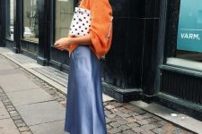 28 an orange jumper, a blue slip midi skirt, colorful trainers and a polka dot clutch won’t let you pass unnoticed