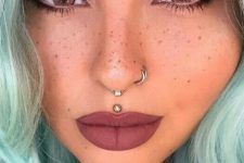 29 a gorgeous double nose hoop piercing and an additional septum hoop for a super rebellious look