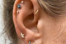 29 a triple lobe piercing, a triple flat piercing, a forward helix piercing done with chic rhinestone hoops and studs look amazing