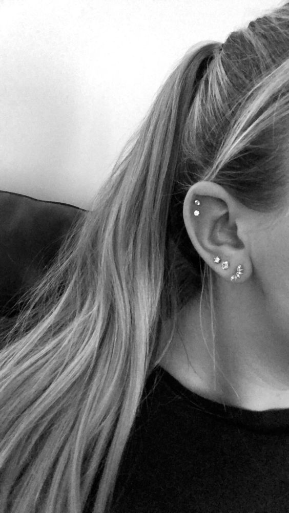 a triple lobe piercing plus a double flat piercing done with beautiful and matching rhinestone studs creating a set