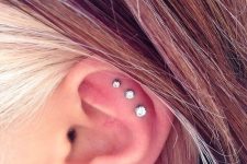 30 a triple love piercing plus a triple flat one, done with silver hoops and rhinestone studs that differ in size but match in look