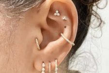 31 bold styling with a double flat, a conch, a triple lobe and a tragus piercing is a very cool and fresh idea to rock