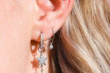 31 celestial ear styling with two hoops with stars, a triple flat piercing with opeal and star studs is wow