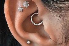 33 elegant ear styling with a triple lobe, a double flat and a daith piercing with chic and shiny studs and a single hoop earring