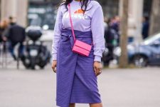 34 a stylish monochromatic look with a lilac printed sweatshirt, a Very Peri printed wrp midi, white boots, a pink bag