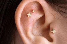 36 whimsy and glam ear styling with a double flat, triple lobe and tragus piercing all done with amazing gold studs and a chain earring