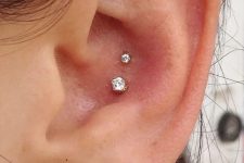 39 lovely ear styling with a double conch piercing with gold studs, stacked lobe peircings with studs and a flat piercing with a monogram earring