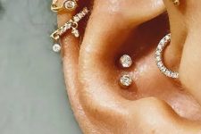 40 a bold and cool ear with a double conch, stacked lobe, a forward helix, stacked helix done with beautiful hoop and stud earrings