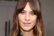 Alexa Chung with midlength curtain bangs and long highlighted layers, she accentuates the shag look even more with her hair pulled back at the sides.