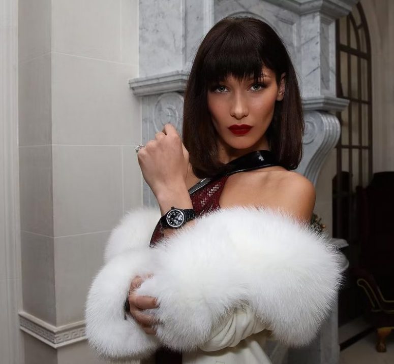 Bella Hadid wearing a brown shoulder-length bob with Birkin bangs for more contoured cheekbones, a bold maroon lip for a statement