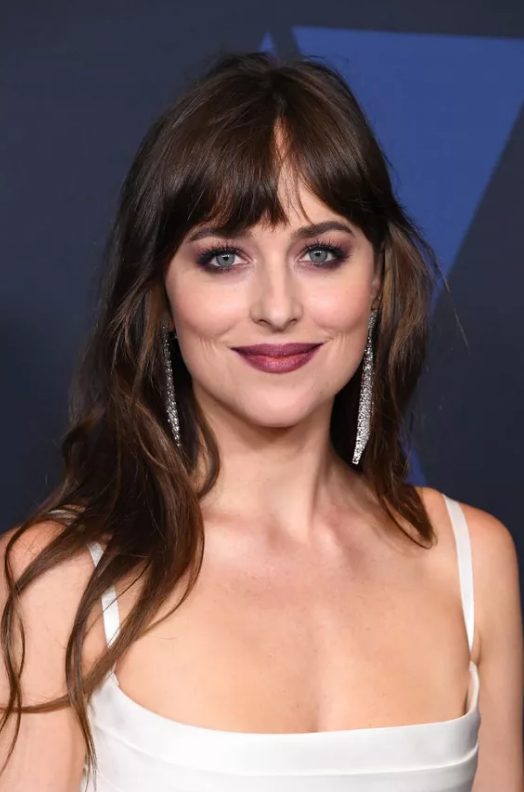 Dakota Johnson's bangs are thick and blunt and soft all at the same time