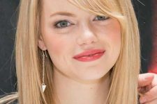 Emma Stone rocking a blonde long bob and side bangs, her stylish and bold feature that she often rocks