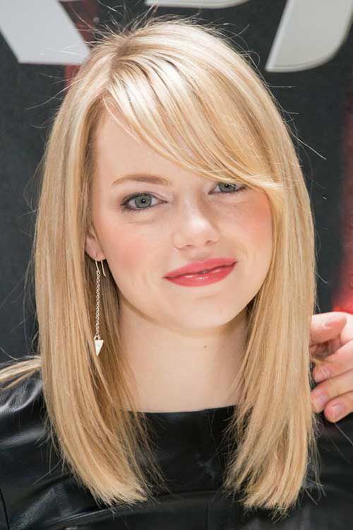 Emma Stone rocking a blonde long bob and side bangs, her stylish and bold feature that she often rocks