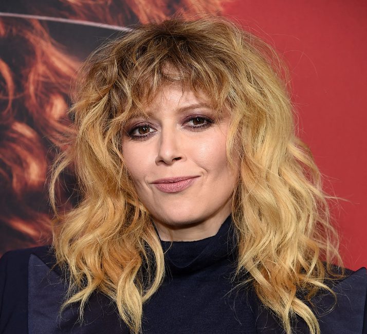Natasha Lyonne's go to cut has those signature layers all over and wispy, curly moon bangs