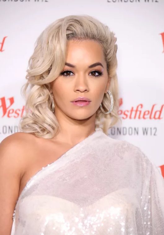 Rita Ora's lifted roots and dramatically curled side bangs have an old Hollywood starlet vibe