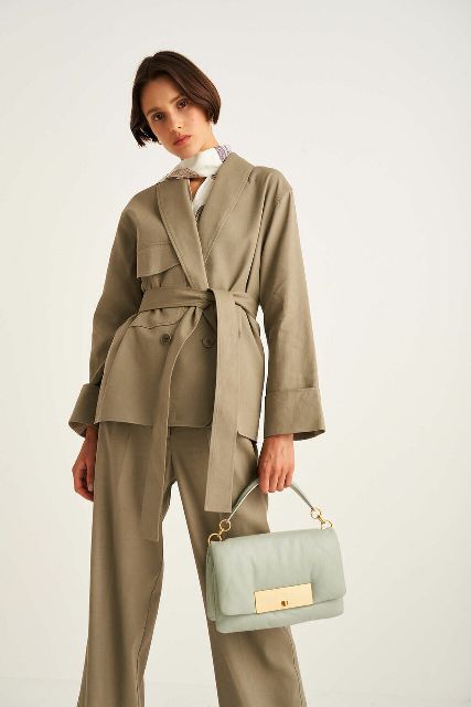 With beige linen loose pants, light blue and golden bag and printed scarf