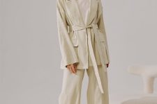 With beige loose top, beige palazzo pants and white flat sandals