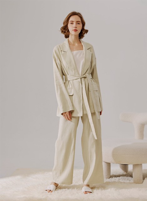 With beige loose top, beige palazzo pants and white flat sandals