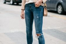 With beige satin loose top, beige leather chain strap bag, navy blue distressed skinny jeans and beige patent leather pumps
