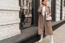 With beige shirt, brown leather midi coat, white leather bag and white lace up mid calf platform boots
