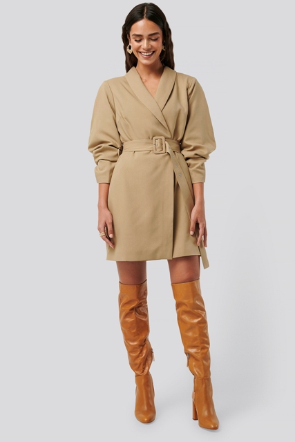 With brown patent leather over the knee boots and golden earrings