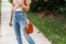 With distressed cropped jeans, red leather rounded bag and brown flat shoes