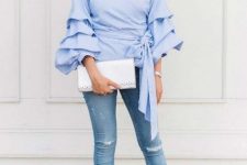 With distressed skinny jeans, silver clutch, embellished pumps and earrings