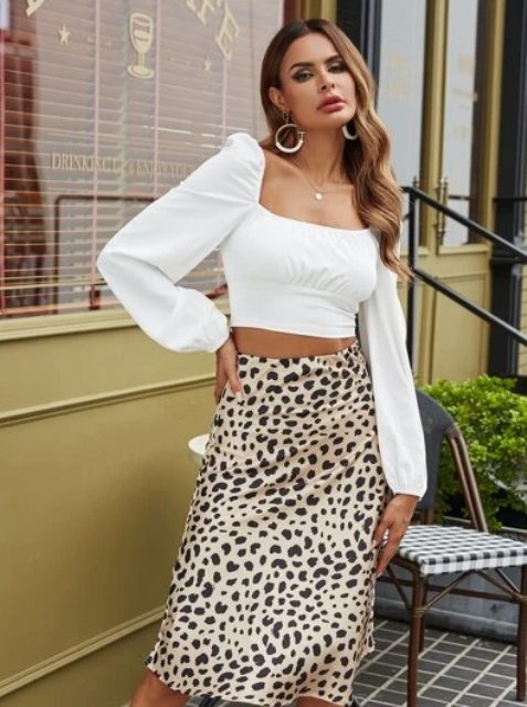 With earrings and leopard printed knee-length skirt