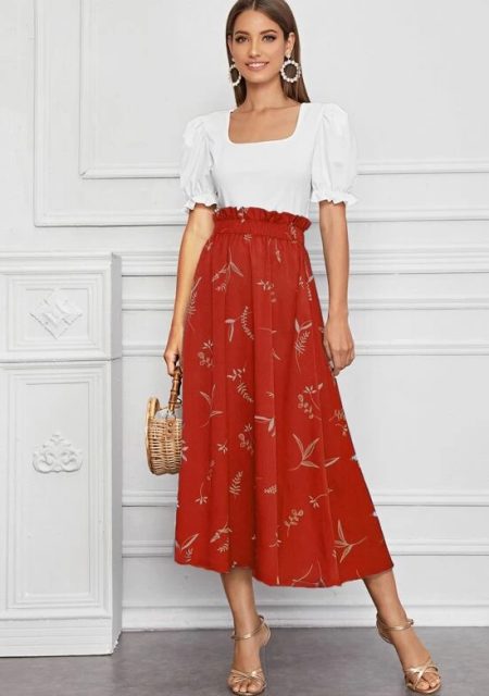 With earrings, red and beige printed high waisted midi skirt, straw bag and golden ankle strap high heels