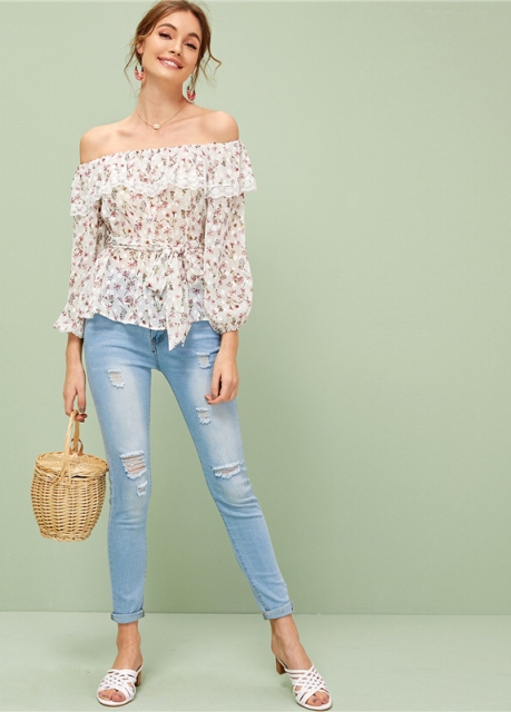 With pale pink earrings, straw bag, light blue distressed cuffed jeans and white low heeled sandals