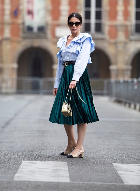 With sunglasses, emerald green pleated midi skirt, black belt, golden chain strap bag and black and beige low heeled shoes