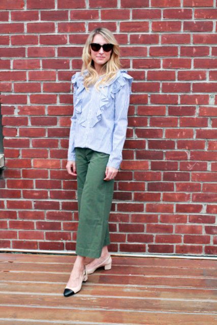 With sunglasses, green cropped pants and black and beige low heeled shoes
