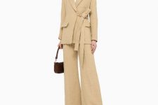 With white button down shirt, beige linen flare pants, dark brown leather bag and low heeled shoes