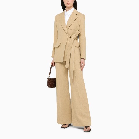 With white button down shirt, beige linen flare pants, dark brown leather bag and low heeled shoes