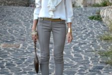With white ruffled blouse, golden bracelet, black leather mini bag and gray pumps