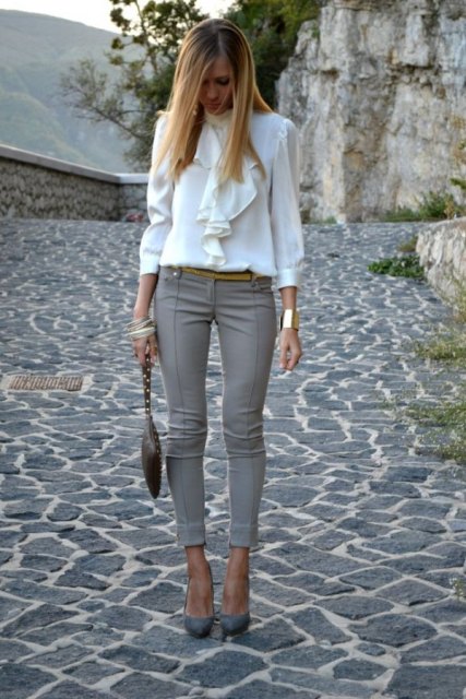 With white ruffled blouse, golden bracelet, black leather mini bag and gray pumps