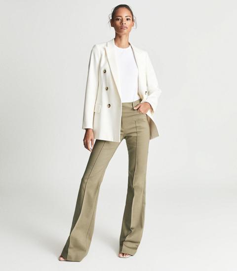 With white t-shrit, white blazer and heeled shoes