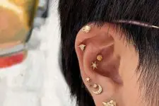 a beautifully celestial styled ear with stacked lobe piercings, a double conch, a forward helix and usual helix piercing with pretty celestial studs