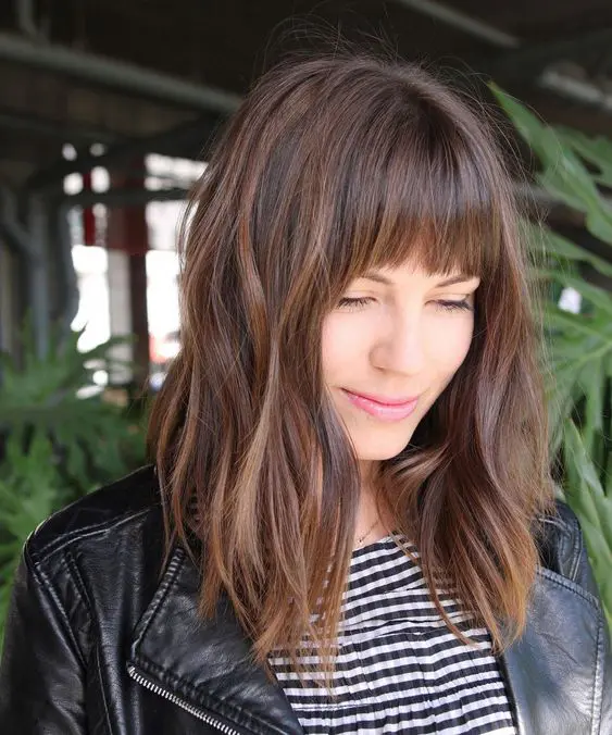 a brown messy shoulder-length bob with blunt bangs is a beautiful and relaxed hairstyle, it's super trendy now