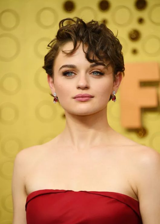 a close-cropped pixie cut with short, curly bangs that cascade across the forehead in layers from shortest to longest looks so flirty and youthful